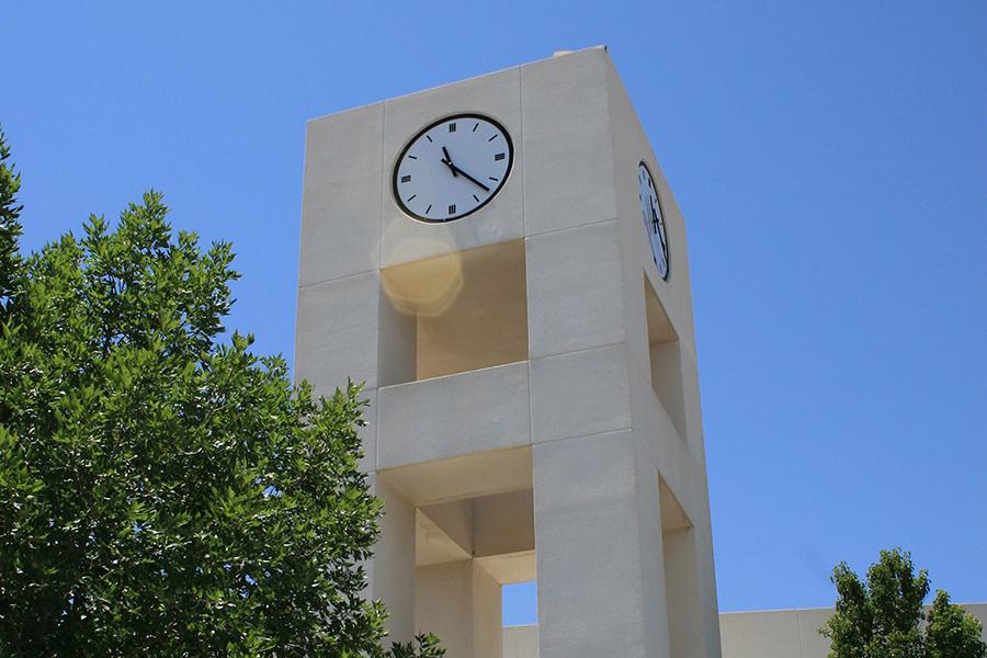 Top of the clocktower against a bright blue sky.